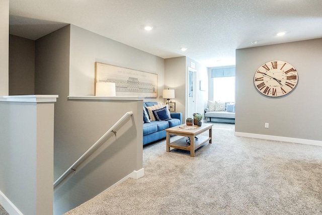 carpeted living room featuring a textured ceiling