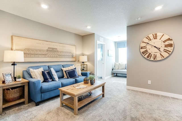 living room with a textured ceiling and light carpet