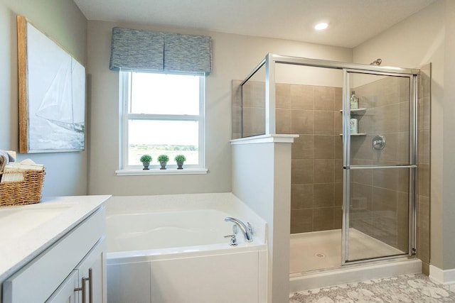 bathroom featuring vanity, a shower stall, a garden tub, and recessed lighting