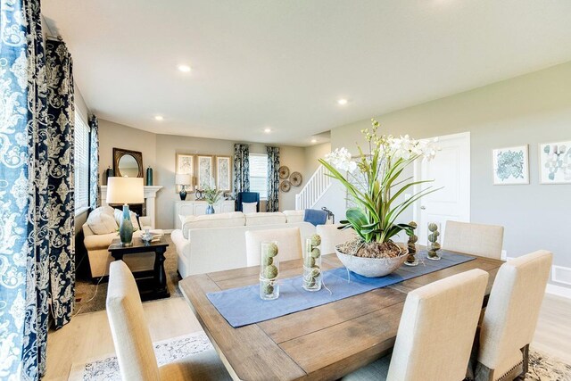 dining space featuring stairway, recessed lighting, and light wood finished floors