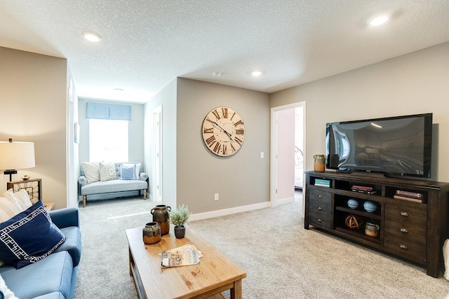 living room featuring recessed lighting, light colored carpet, baseboards, and a textured ceiling