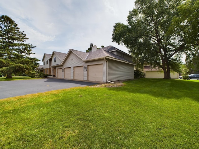 view of side of property with a lawn