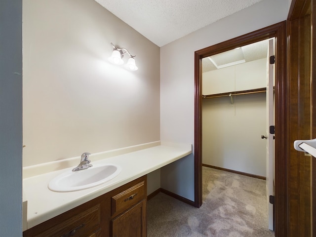 bathroom featuring a textured ceiling and vanity