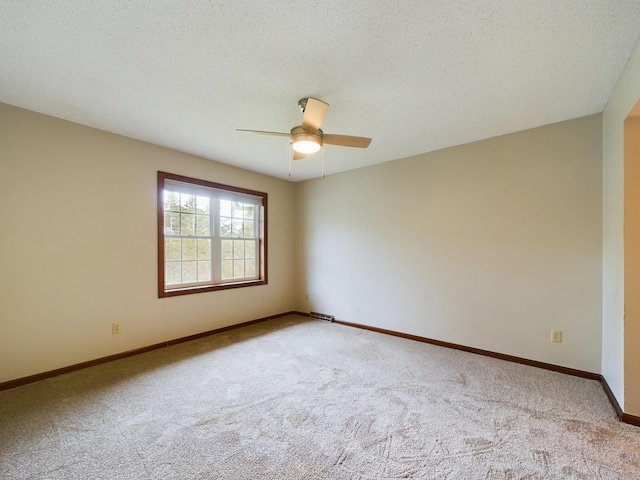 carpeted spare room featuring a textured ceiling and ceiling fan