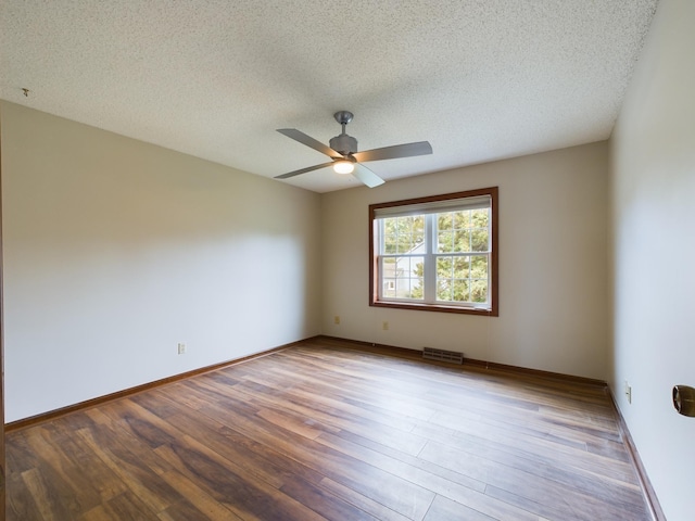 spare room with ceiling fan, a textured ceiling, and hardwood / wood-style flooring