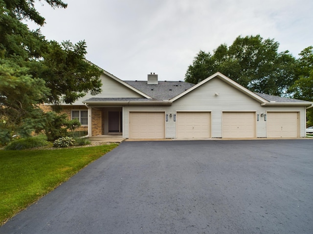 view of front of home featuring a front yard and a garage