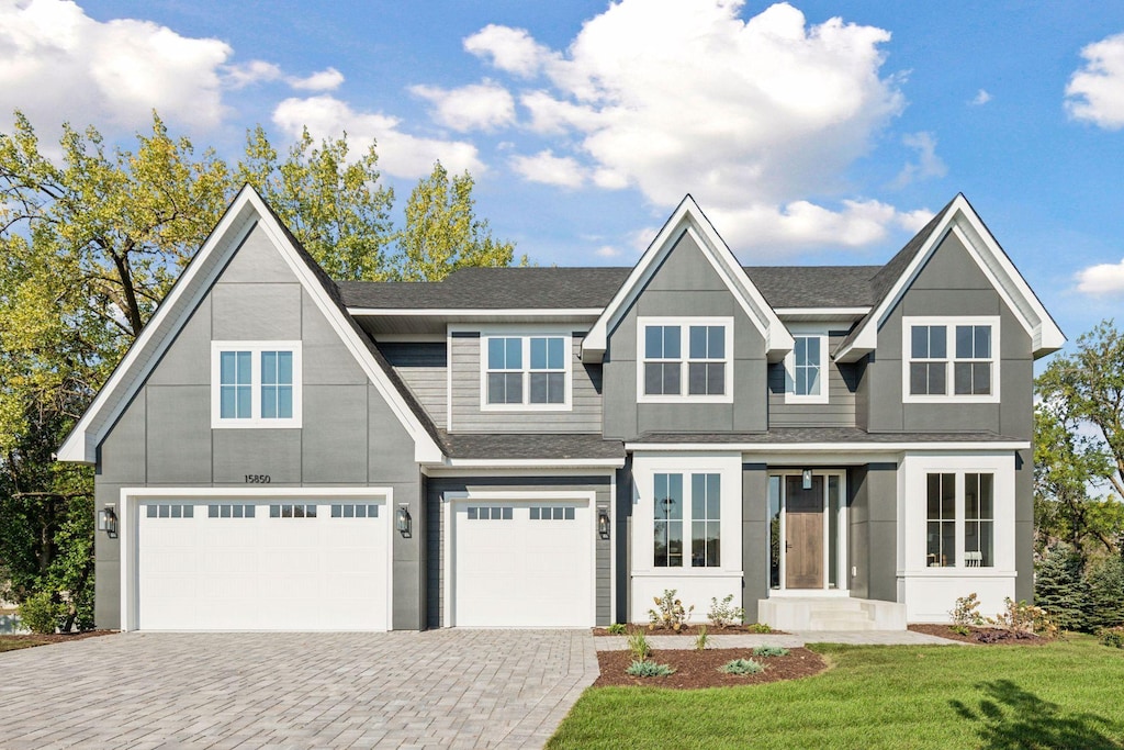 view of front of home featuring a garage and a front yard