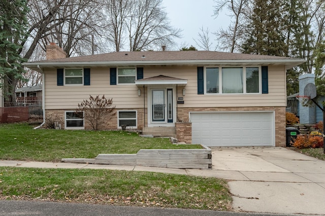 raised ranch with a front yard and a garage