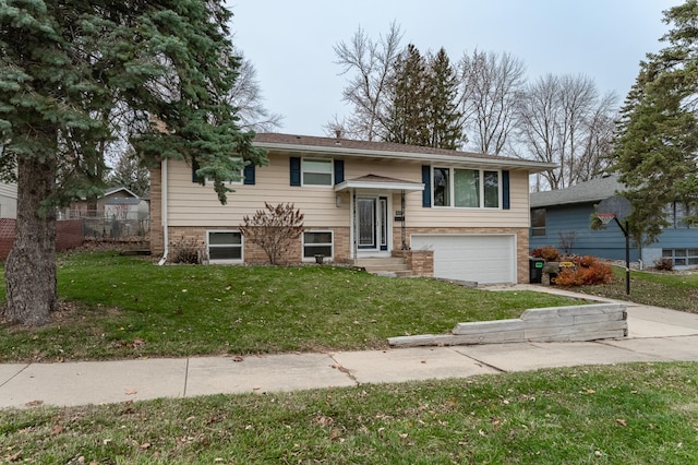 split foyer home with a front yard and a garage