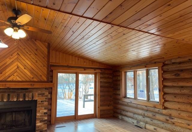 unfurnished living room featuring ceiling fan, log walls, wooden ceiling, and vaulted ceiling