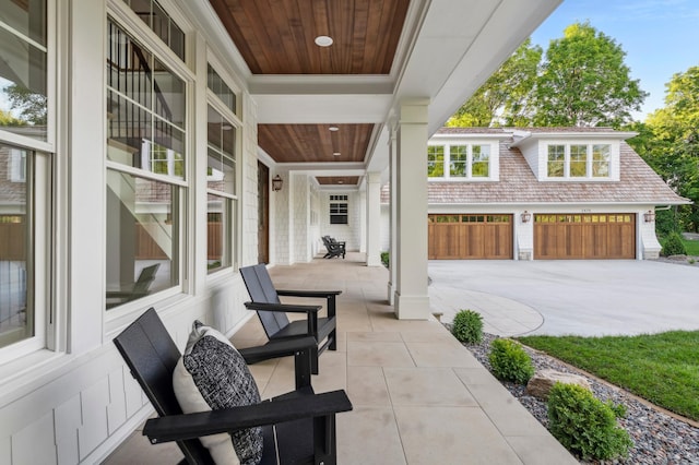 view of patio with covered porch and a garage