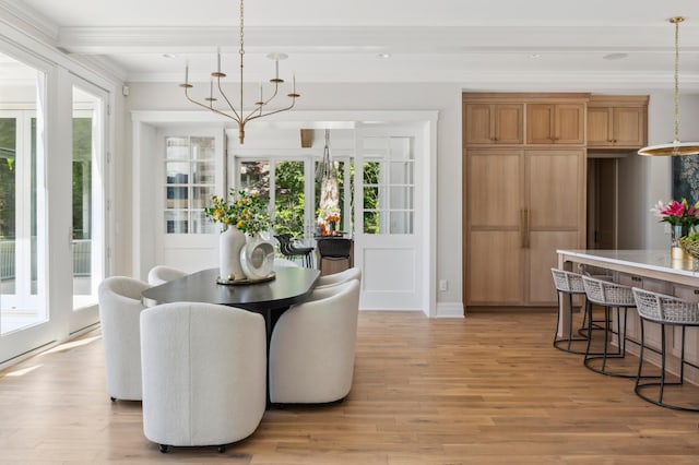 dining area featuring a healthy amount of sunlight, ornamental molding, and light hardwood / wood-style flooring