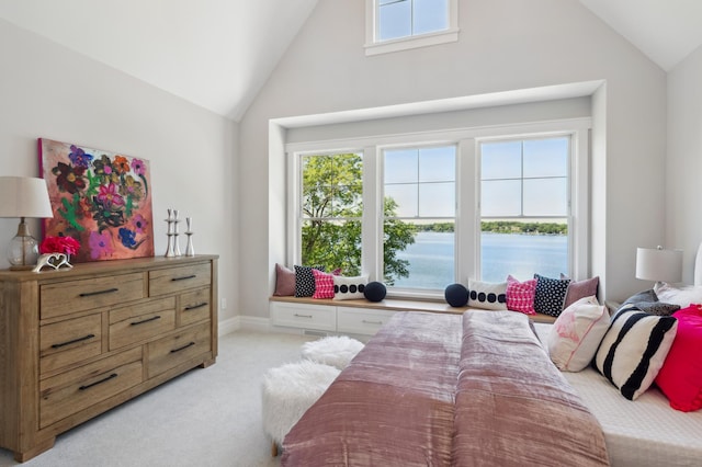 bedroom with a water view, light colored carpet, and vaulted ceiling