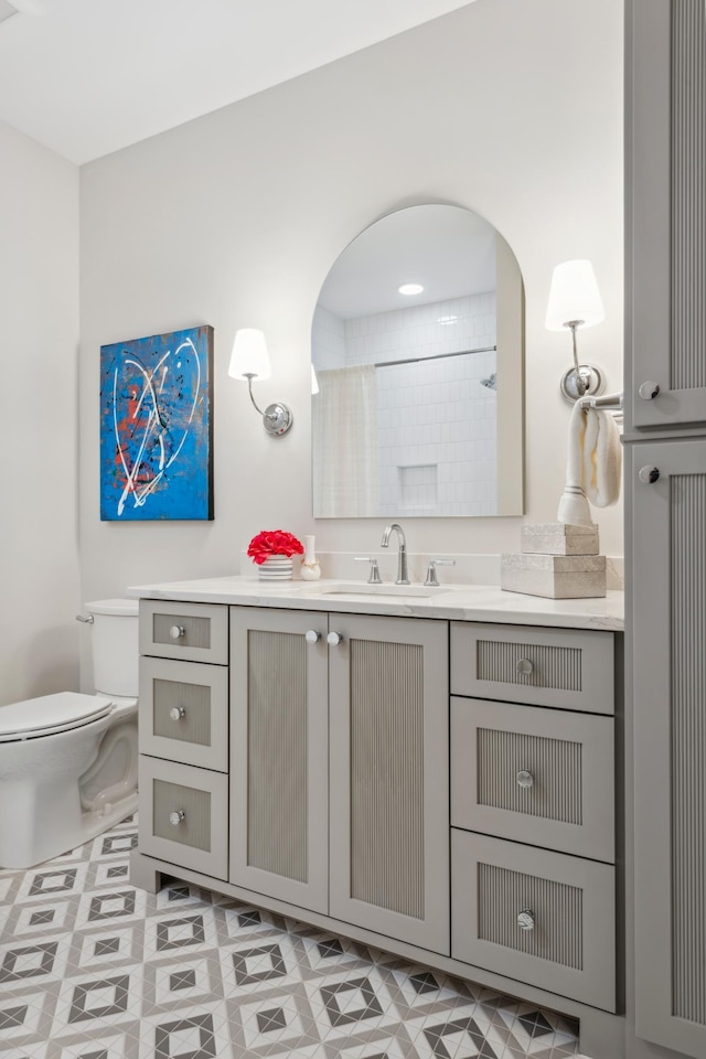 bathroom featuring vanity, toilet, and walk in shower