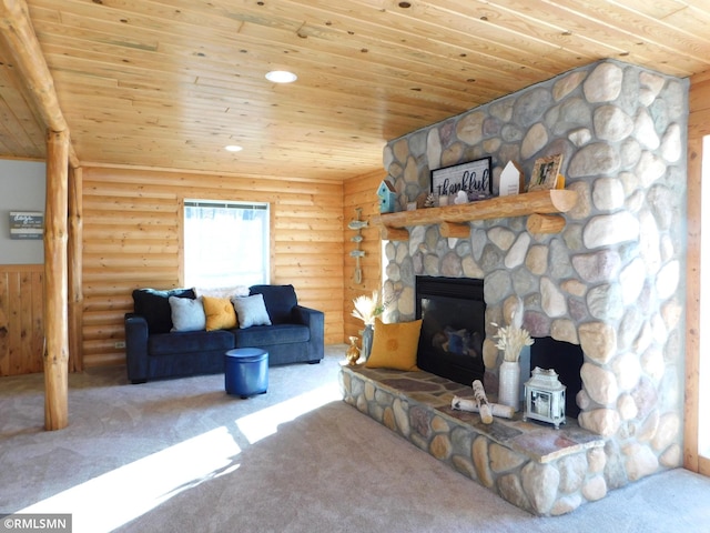 carpeted living room with log walls, a fireplace, and wooden ceiling