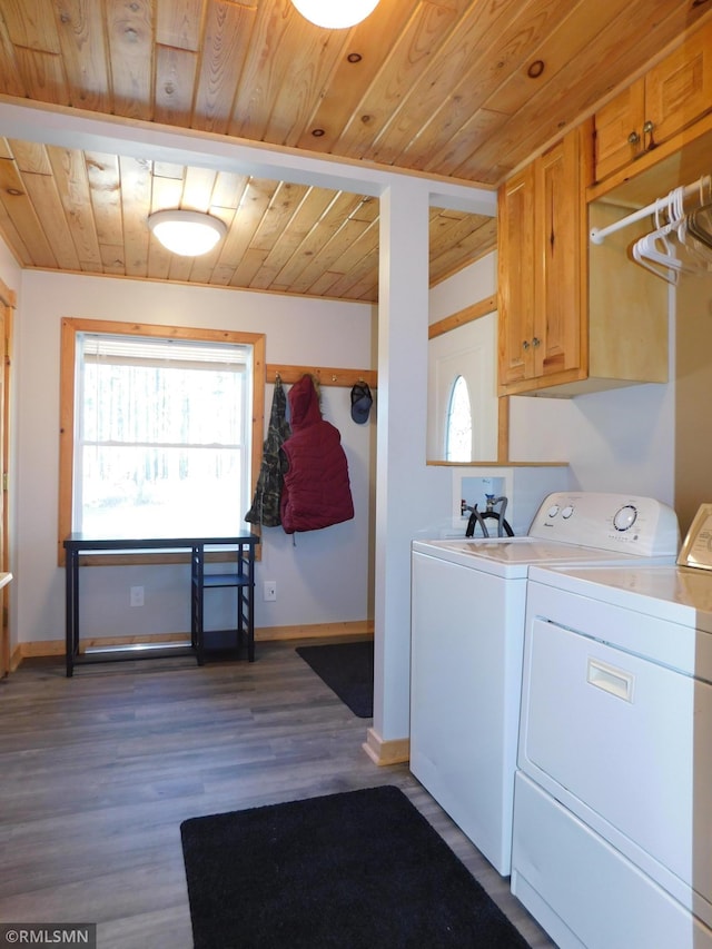 laundry area featuring wood-type flooring, independent washer and dryer, cabinets, and wood ceiling