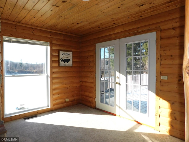 entryway featuring a healthy amount of sunlight, carpet flooring, french doors, and wooden ceiling