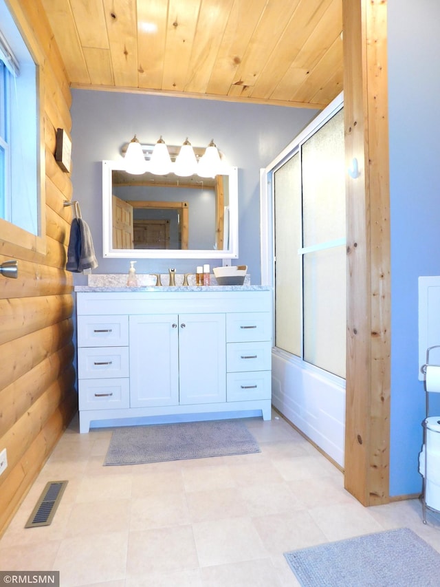 bathroom with rustic walls, shower / bath combination with glass door, vanity, and wooden ceiling