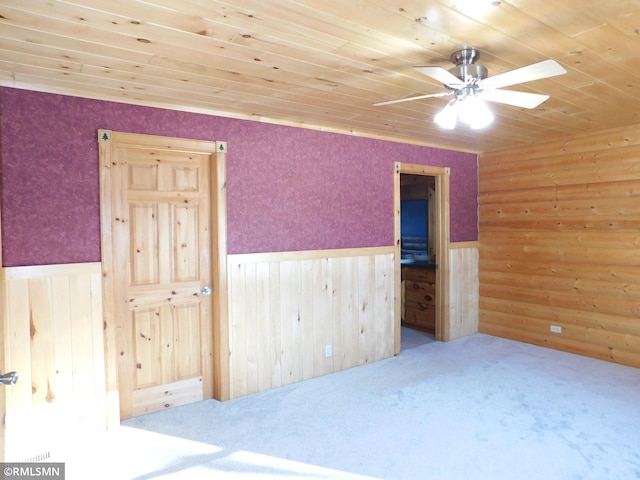 interior space with carpet floors, ceiling fan, and wood ceiling