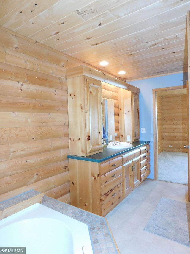 bathroom featuring rustic walls, sink, and wooden ceiling