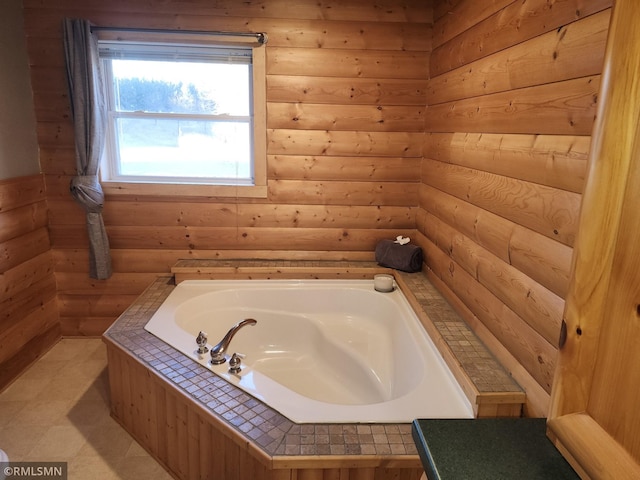 bathroom with a bathtub and log walls