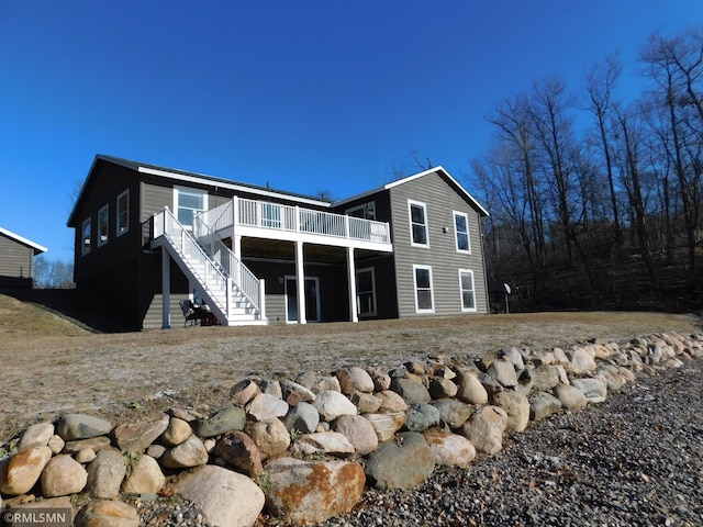 rear view of house featuring a wooden deck