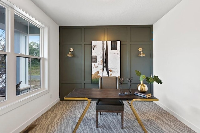 office featuring baseboards, visible vents, a decorative wall, and a textured ceiling