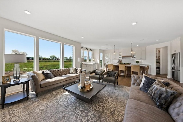 living area featuring dark wood-style floors and recessed lighting