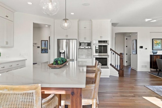 dining area with baseboards, visible vents, wood finished floors, stairs, and recessed lighting