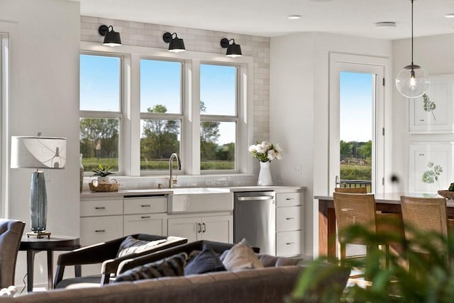 interior space featuring pendant lighting and dishwasher