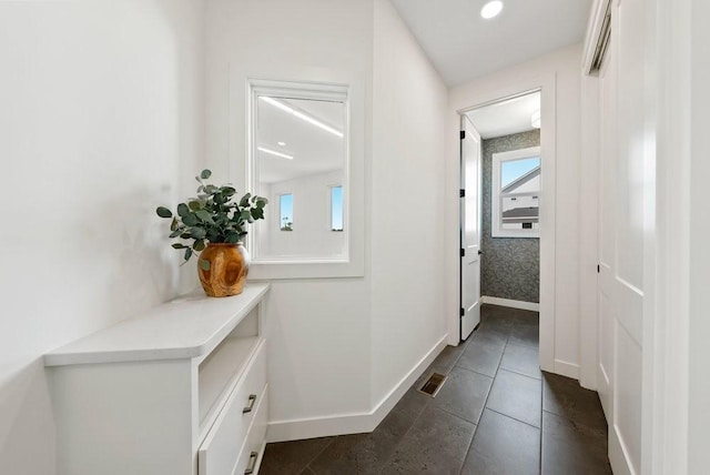 hallway featuring visible vents and baseboards