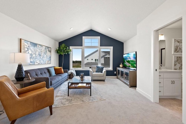 living room featuring light colored carpet, vaulted ceiling, a textured ceiling, and baseboards