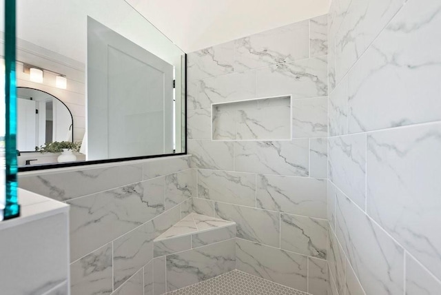 full bathroom featuring tiled shower