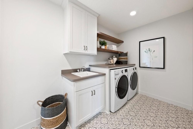 clothes washing area featuring recessed lighting, a sink, baseboards, independent washer and dryer, and cabinet space