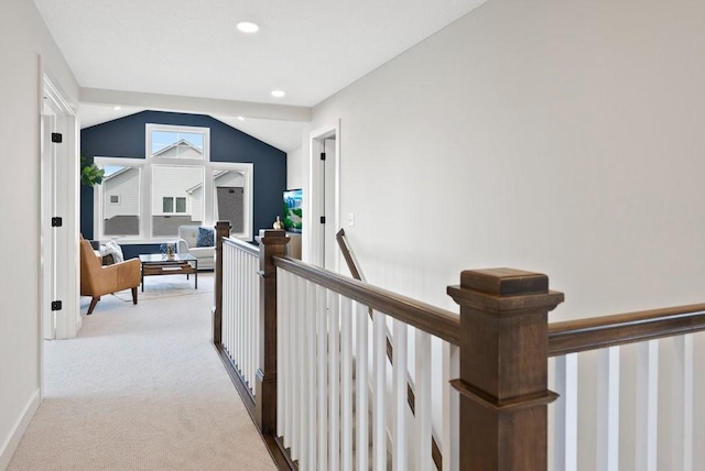 hallway with light carpet, recessed lighting, lofted ceiling, and an upstairs landing