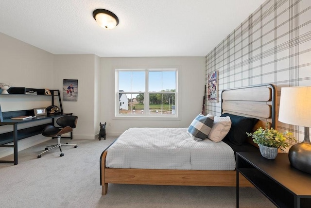 carpeted bedroom featuring baseboards and a textured ceiling