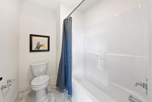 bathroom with marble finish floor, shower / bath combo, toilet, and baseboards