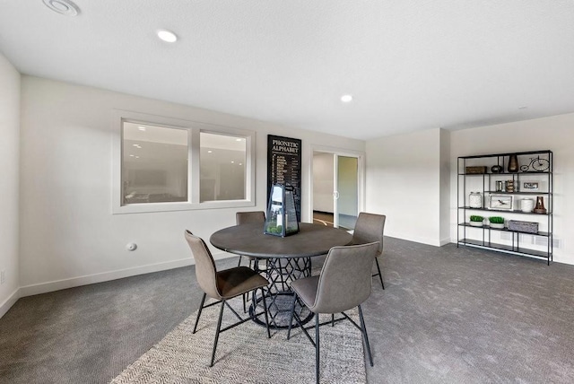 dining area featuring recessed lighting, dark carpet, and baseboards