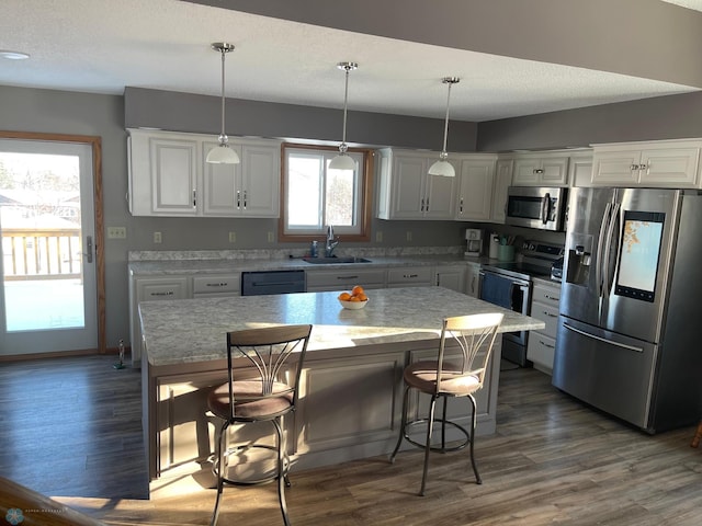 kitchen featuring white cabinets, stainless steel appliances, and a kitchen island