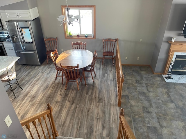 dining area with a chandelier and dark hardwood / wood-style floors