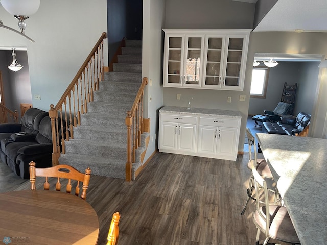 staircase featuring hardwood / wood-style floors and bar