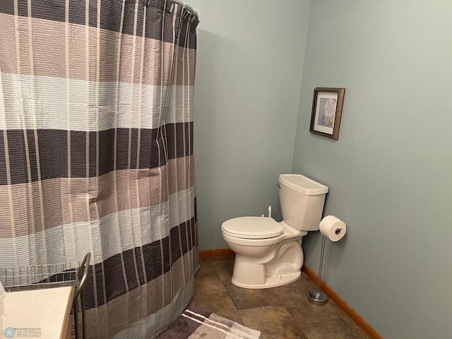 bathroom featuring walk in shower and toilet