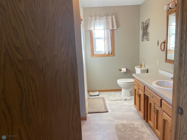 bathroom featuring vanity and toilet