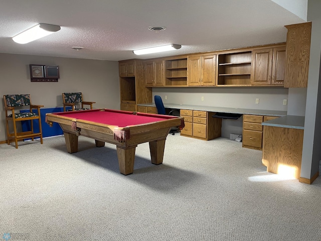 playroom featuring light carpet, a textured ceiling, built in desk, and billiards