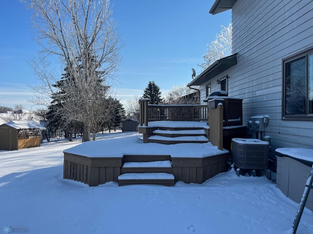 snowy yard featuring central AC