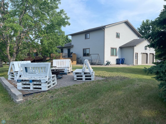 back of house featuring a lawn and a wooden deck