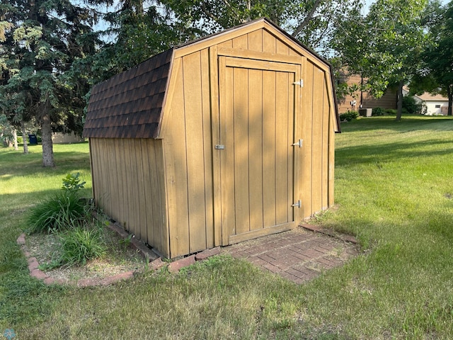 view of outbuilding with a lawn