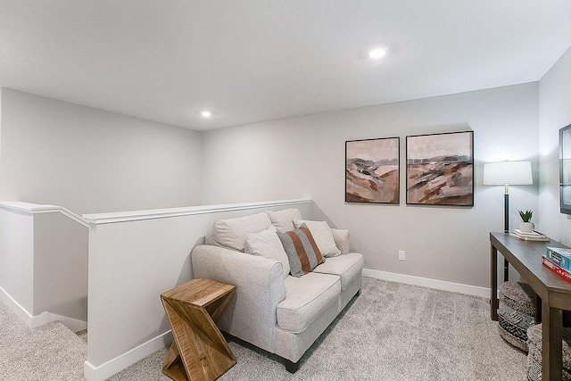 living area featuring light carpet