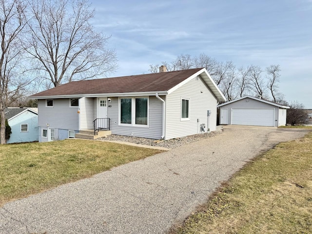 ranch-style house featuring an outbuilding, a front lawn, and a garage