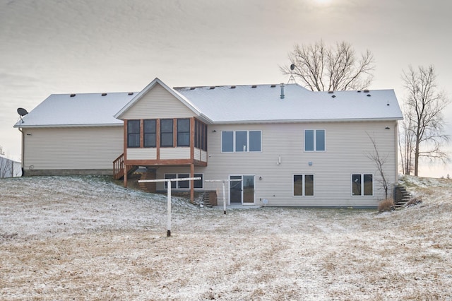 rear view of house featuring a sunroom